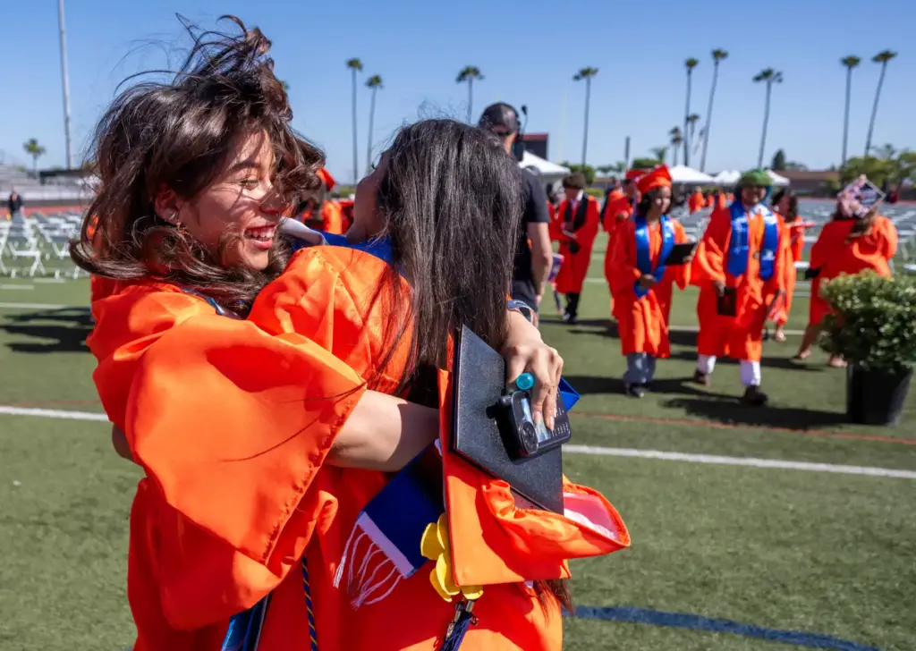 Orange High School graduates celebrate together following their graduation ceremony...