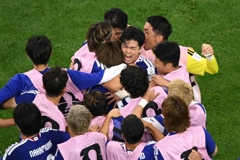 Japan celebrates a goal during the World Cup Group F...