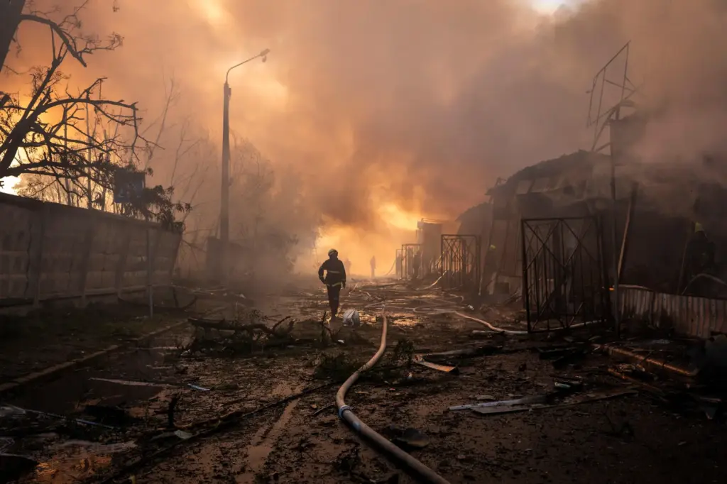 Firefighters try to put out a fire at a city marketplace following a Russian attack.