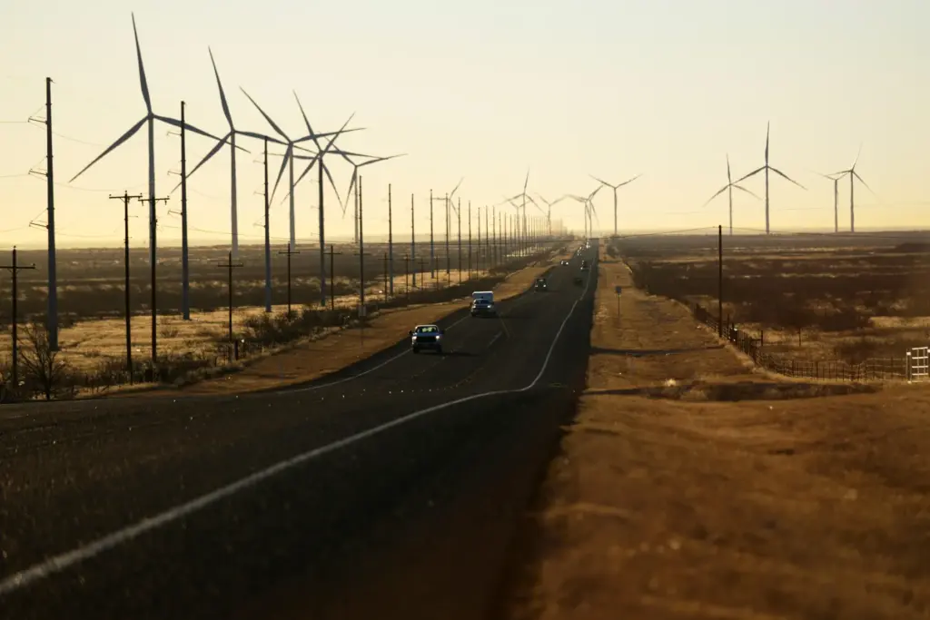 FILE – Wind turbines are visible along Route 176 as...