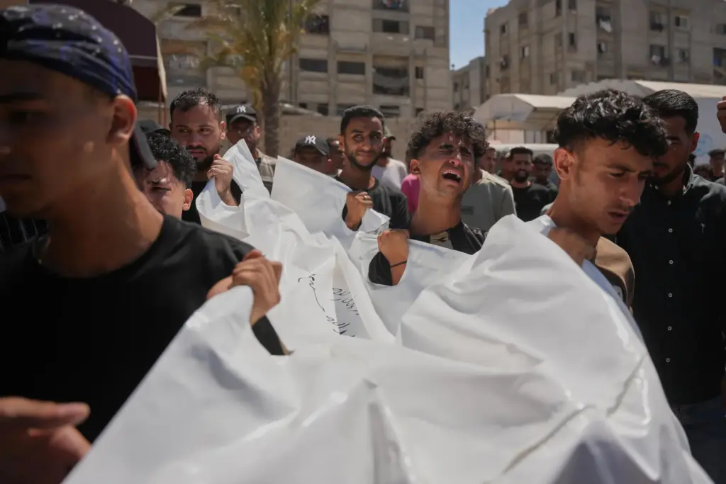 Mourners carry the body of Palestinian Abdullah Moussa, 30, who...