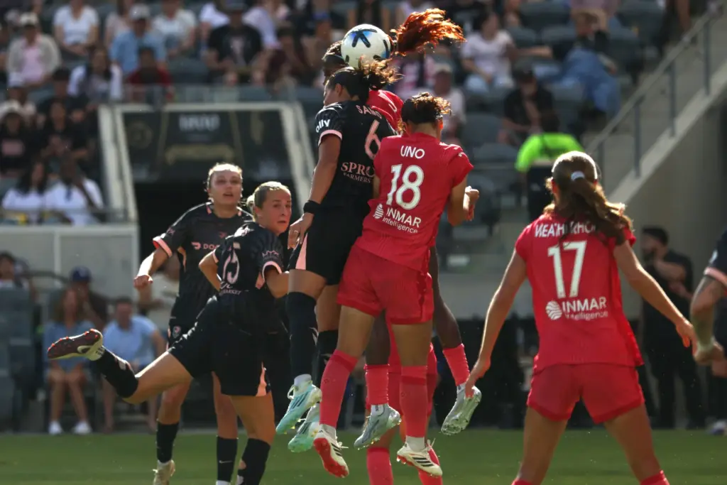 Angel City FC defender Emily Sams (6) heads the ball...