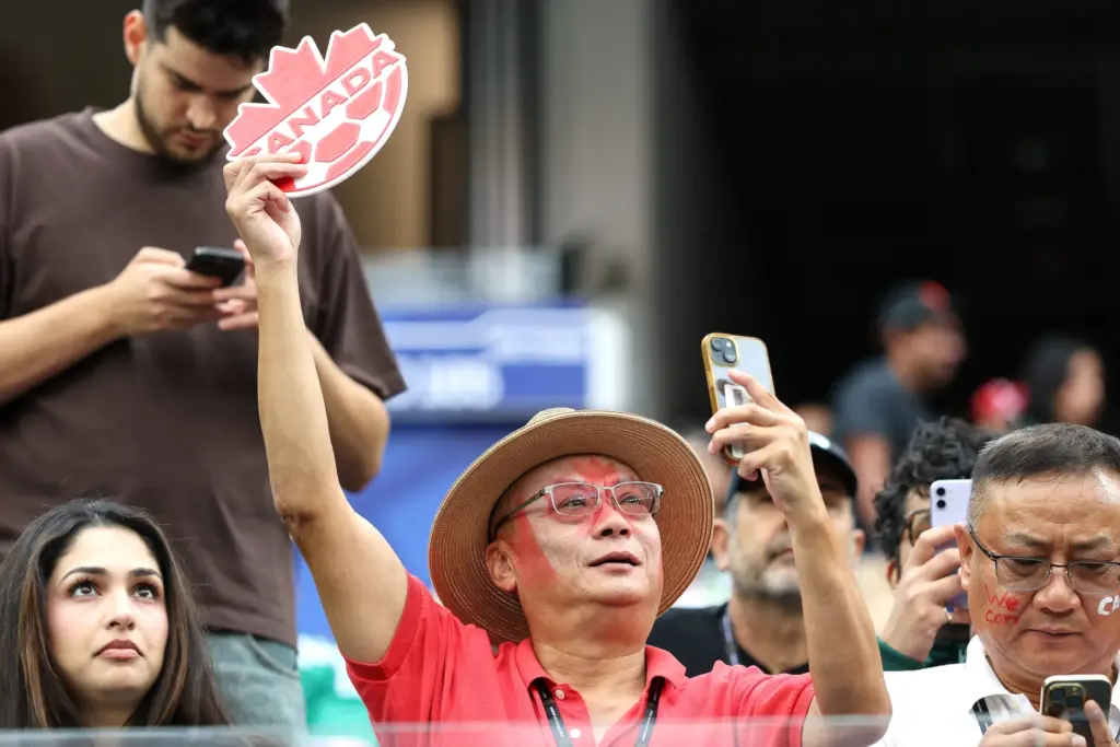 A Canada fan holds up a sign before the start...