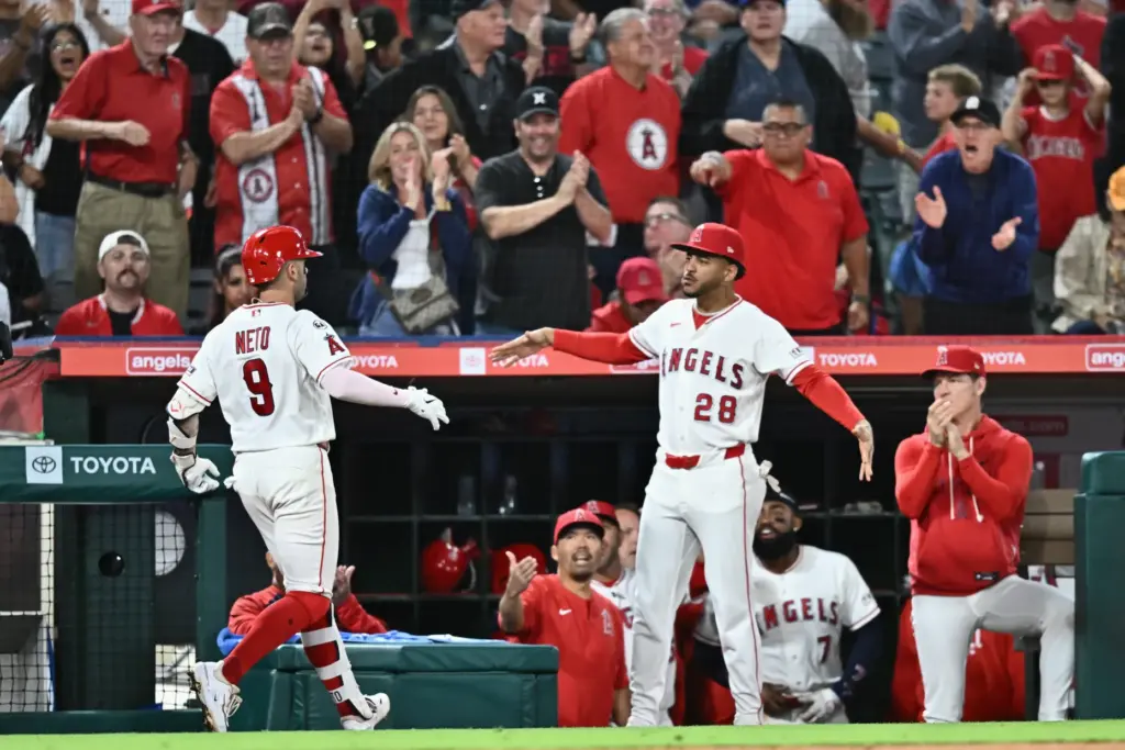 The Angels’ Zach Neto, left, is greeted by teammate Jose...