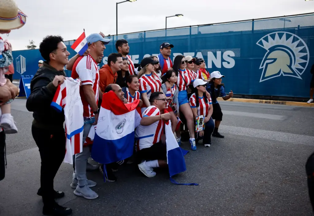 Soccer fans, some wearing Paraguayâs soccer jersey, pose for a...