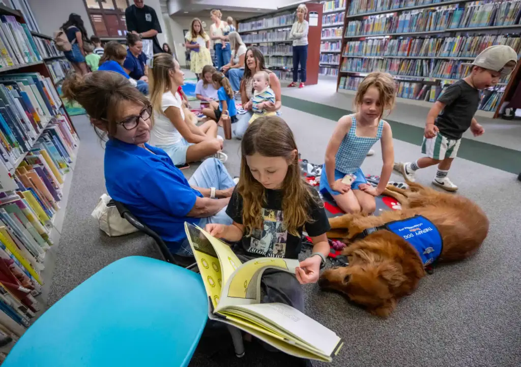 Piper, 10, of Ladera Ranch turns a page as she...