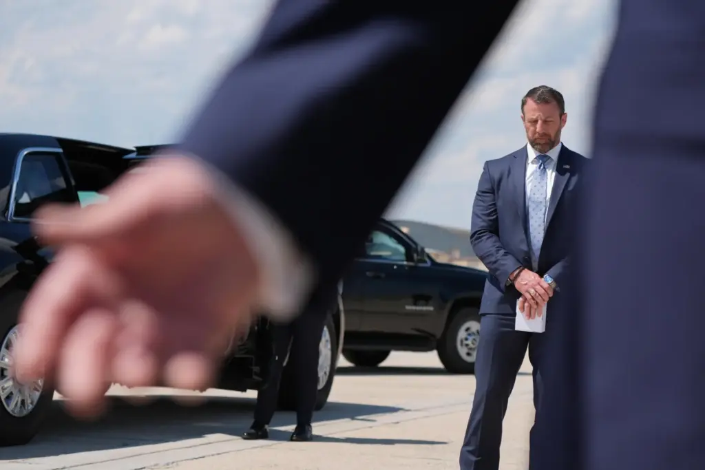 Homeland Security Secretary Markwayne Mullin listens as President Donald Trump speaks.