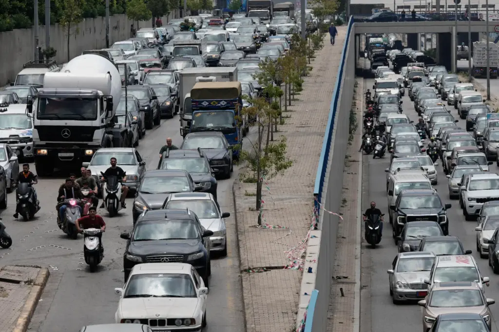 Cars sit in traffic on a highway as residents flee following an Israeli threat.