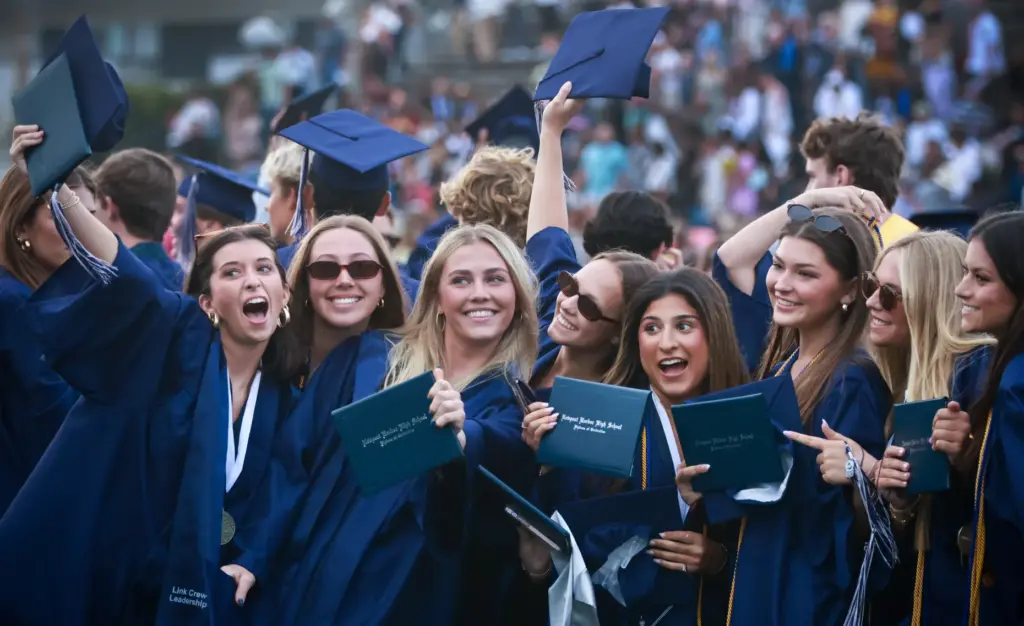 Graduates pose for photos after graduating from Newport Harbor High...