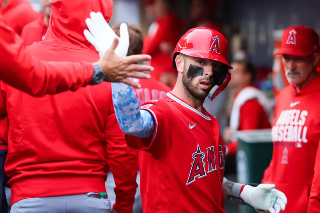 The Angels’ Zach Neto celebrates in the dugout after hitting...
