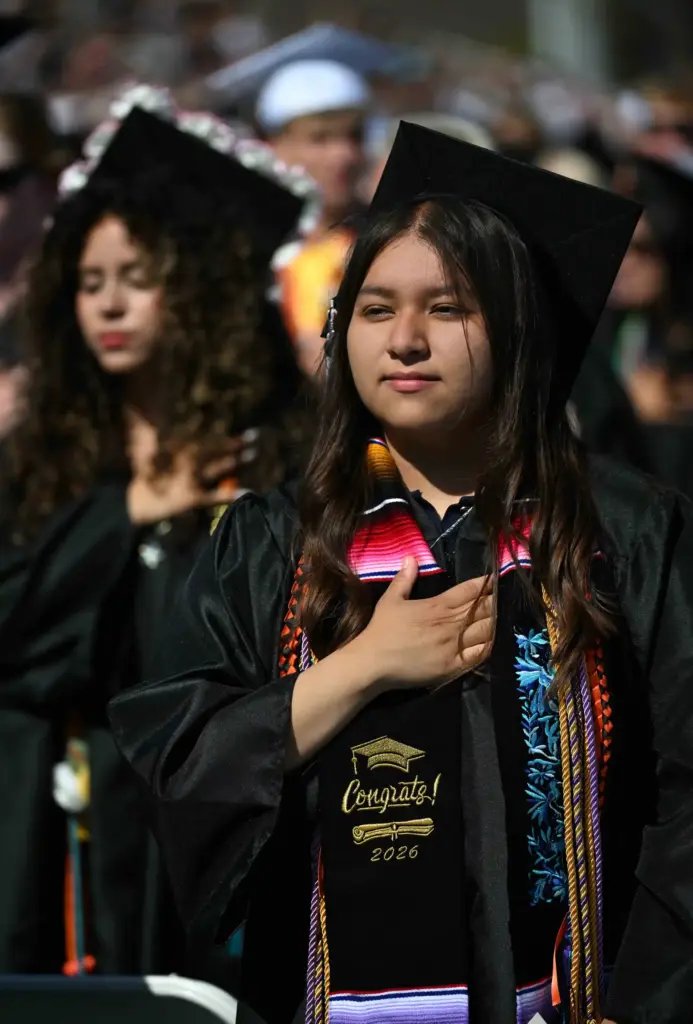 Brisa Torres stands with her classmates for the singing of...