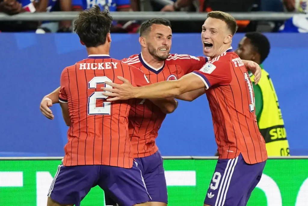 Scotland’s John McGinn (7) celebrates with teammate’s Aaron Hickey (2)...