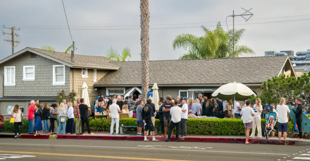 Laguna Beach residents gather for a ribbon-cutting celebration for KXFM...