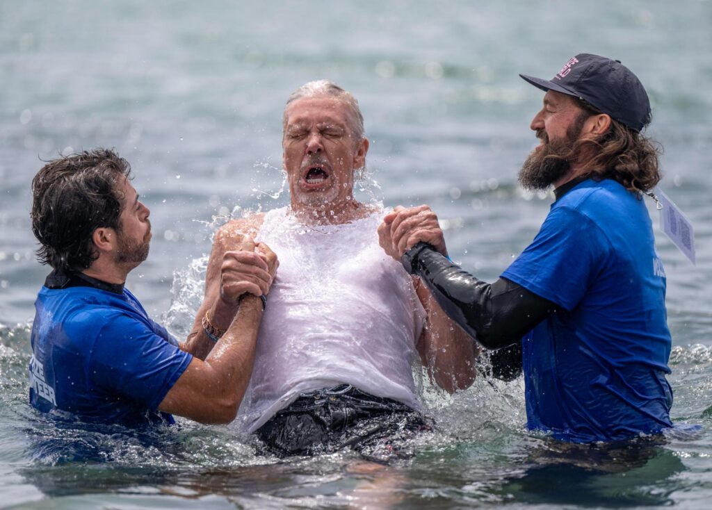 Baptism volunteers Cody Novini, left, and Pastor Ben Houston from...