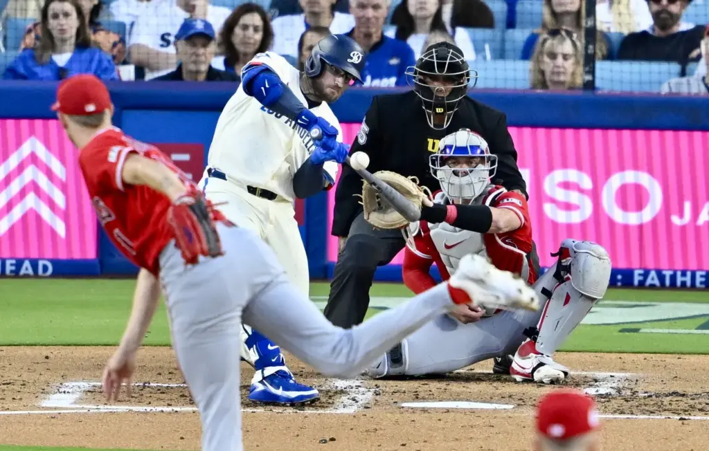 Max Muncy #13 of the Dodgers breaks his bat on...