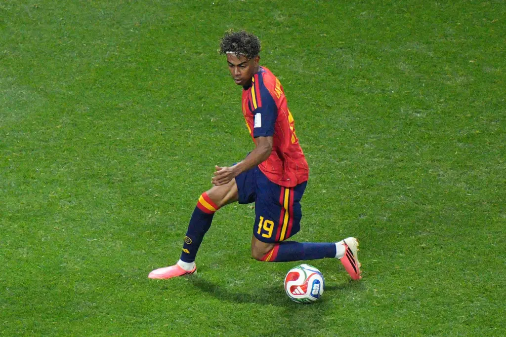 Spain’s Lamine Yamal (19) moves the ball during the World...