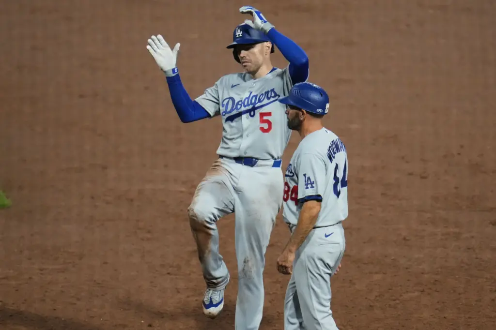 The Dodgers’ Freddie Freeman, left, celebrates next to first base...