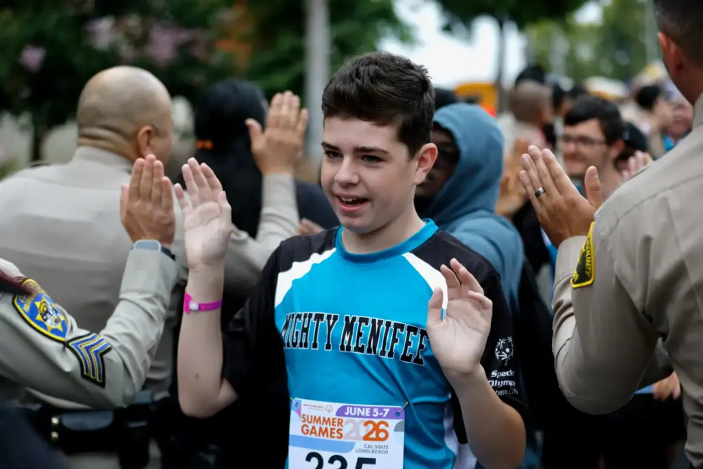 Athletes are greeted by scores of law officers as the...