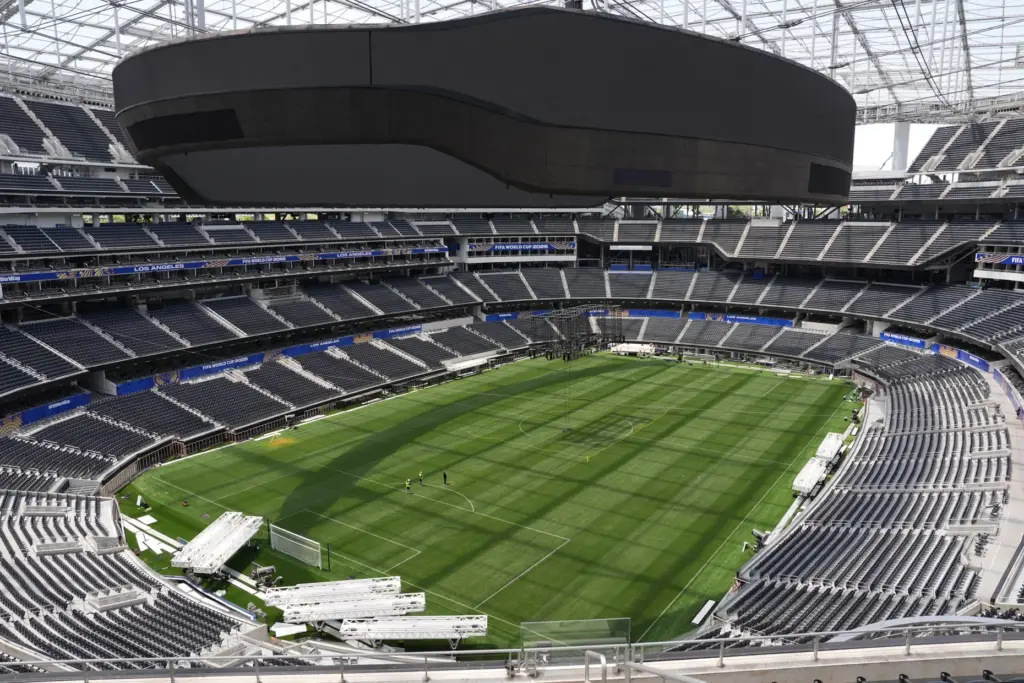 Workers prepare the playing surface at SoFi Stadium on May...