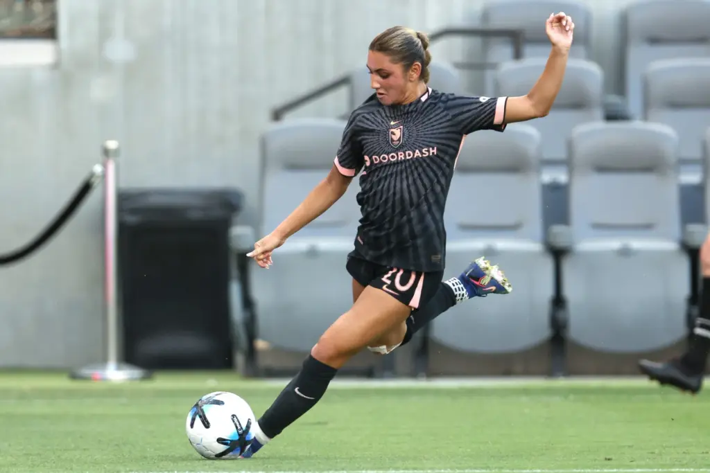 Angel City FC defender Gisele Thompson winds up to kick...
