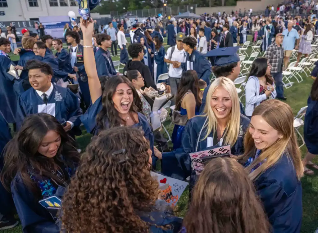 Friends celebrate together at the conclusion of their graduation ceremony...