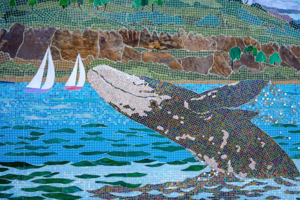 A mosaic by artist Lance Jost depicting a breaching humpback...