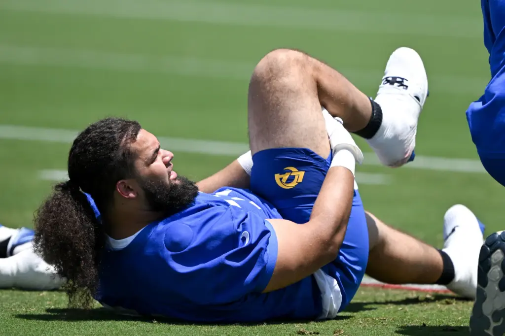 Rams offensive lineman Keagen Trost stretches during an OTA practice...