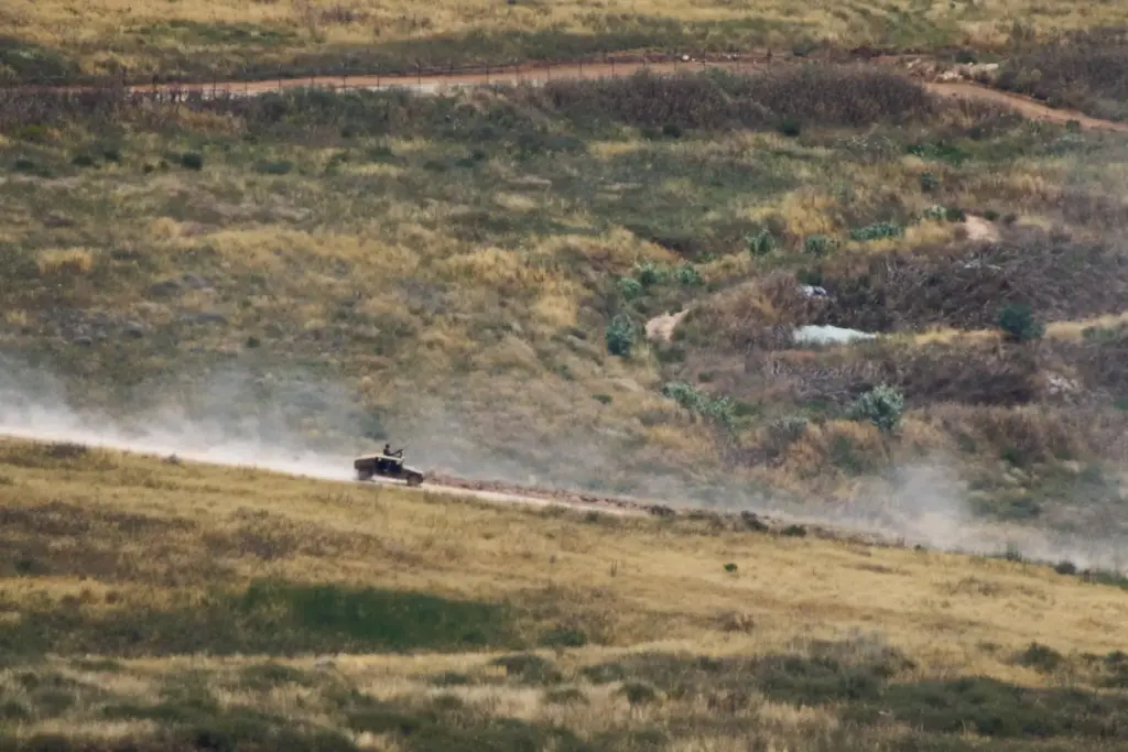 Israeli soldiers drive in southern Lebanon as seen from northern...