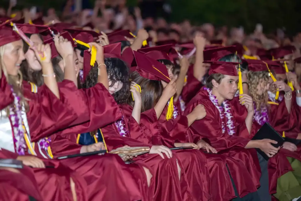Graduates move their tassels from right to left as they...