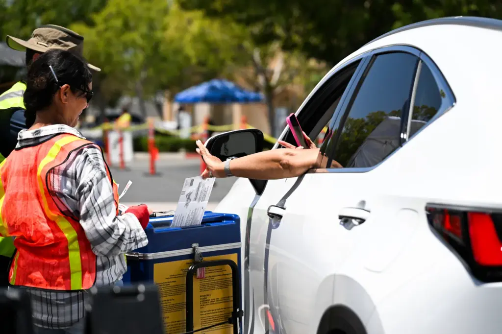 A drive-through ballot drop-off station is set up Monday, June...