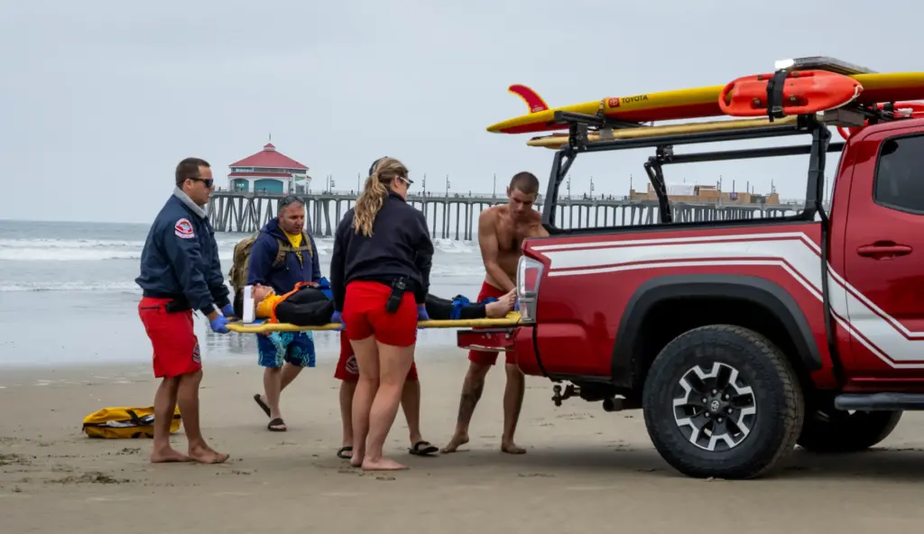Lifeguards transport victim Kyle Costa, 11, during a drill with...