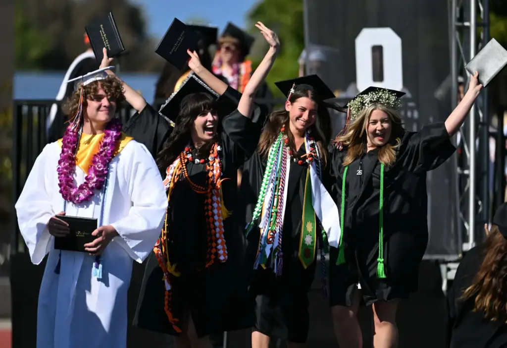 Graduates show your enthusiasm after receiving their diploma during the...