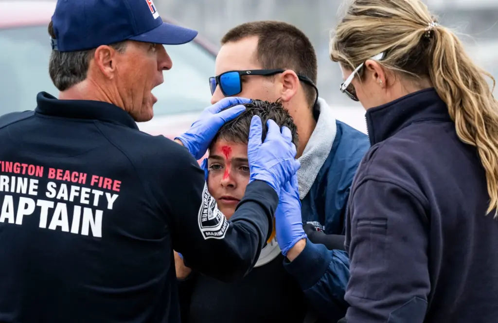 Lifeguards tend to victim Kyle Costa, 11, during a drill...