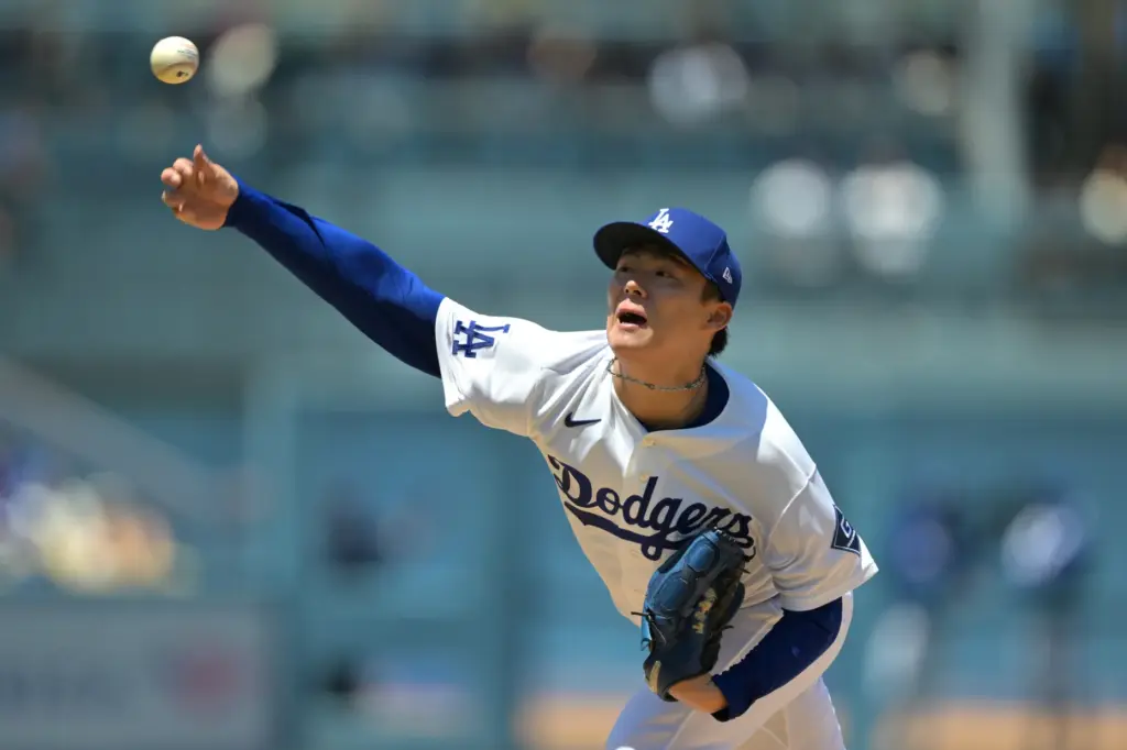 Dodgers pitcher Yoshinobu Yamamoto delivers to the plate during the...