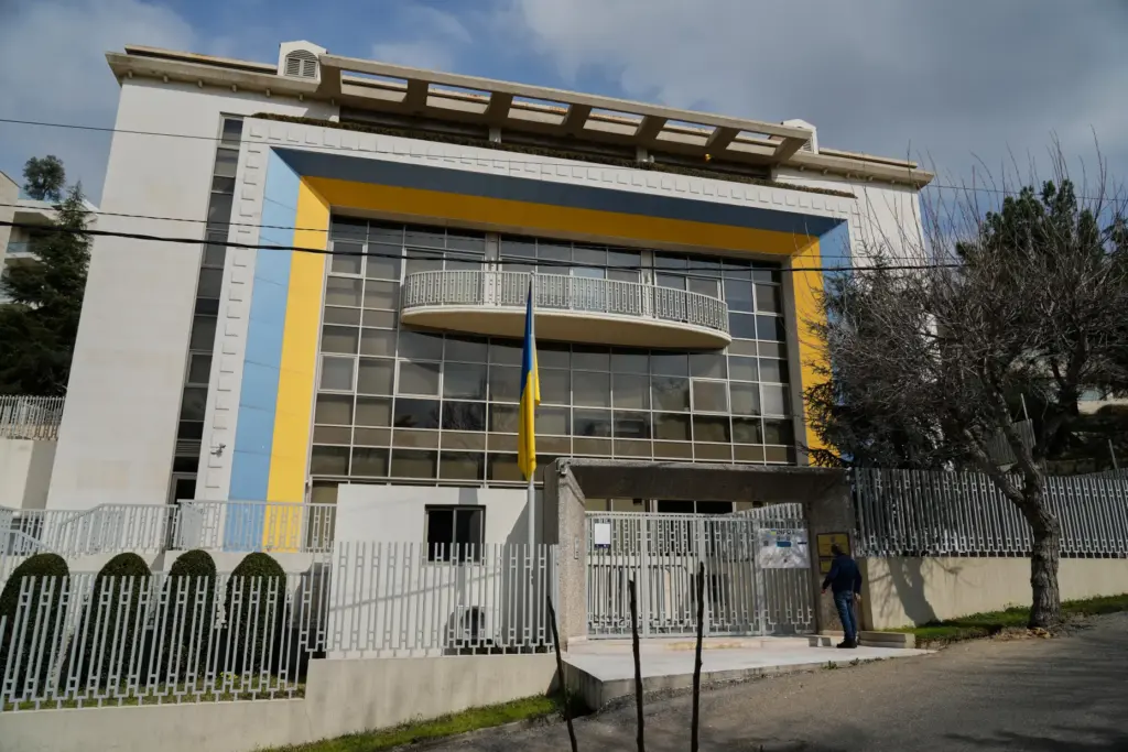 A man stands at the entrance of the Ukrainian Embassy in Yarzeh.