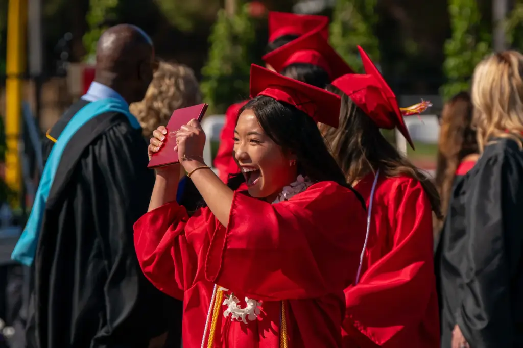Sophie Ke shows off her diploma during the Woodbridge High...