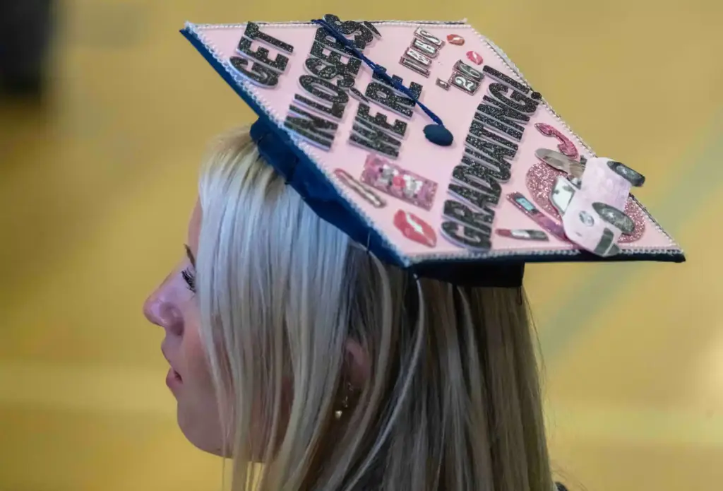 Abigail Licht sports a customized graduation cap that reads, âget...