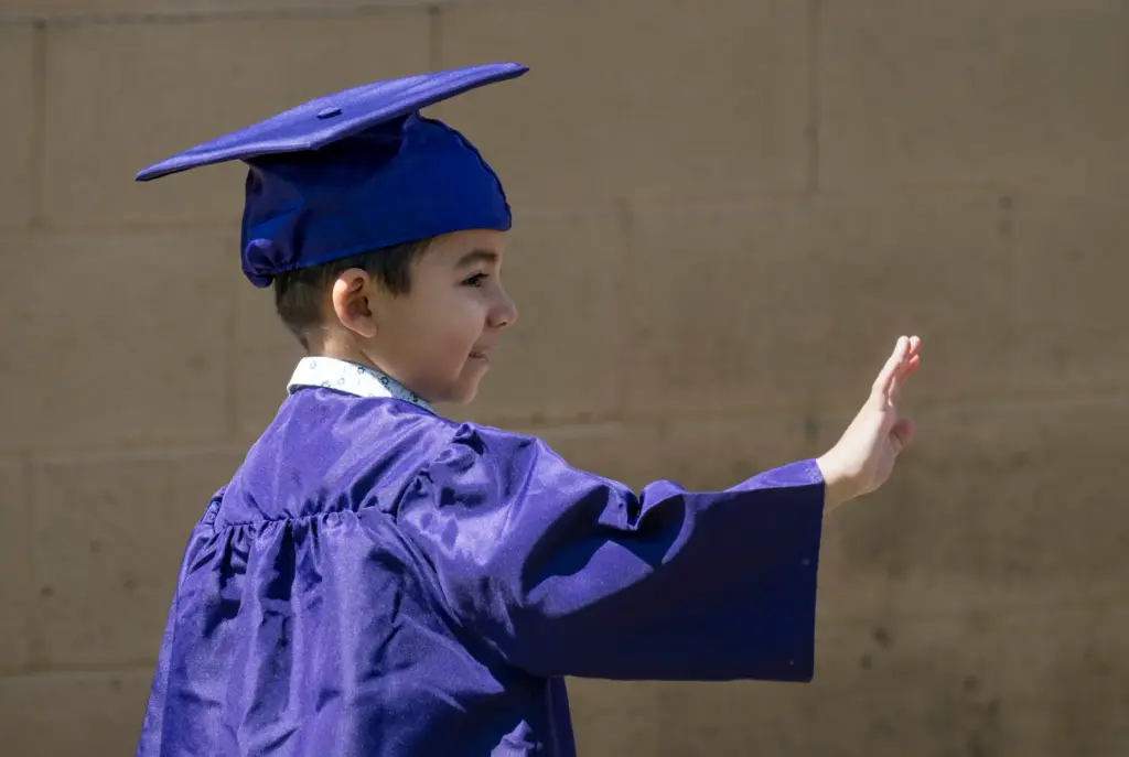 Michael Garcia waves to his supporters during his preschool promotion...