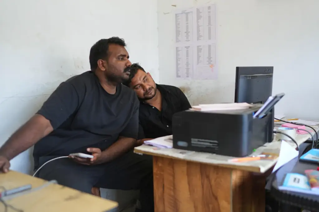 Safeer Mohammed Koorimannil leans on the shoulder of his brother, Jouhar Babu.
