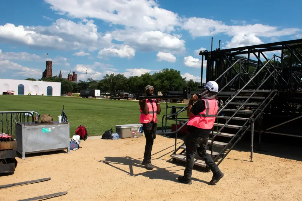 Workers build the stage for the Great American State Fair.