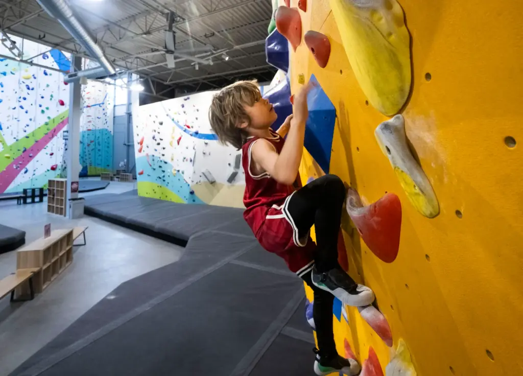 Creed Howell, 7, climbs on the bouldering wall during Rock...
