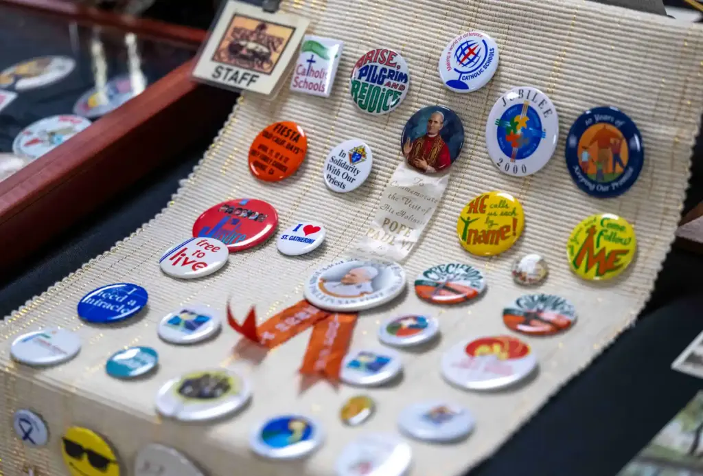 A collection of Catholic buttons sits on display in a...