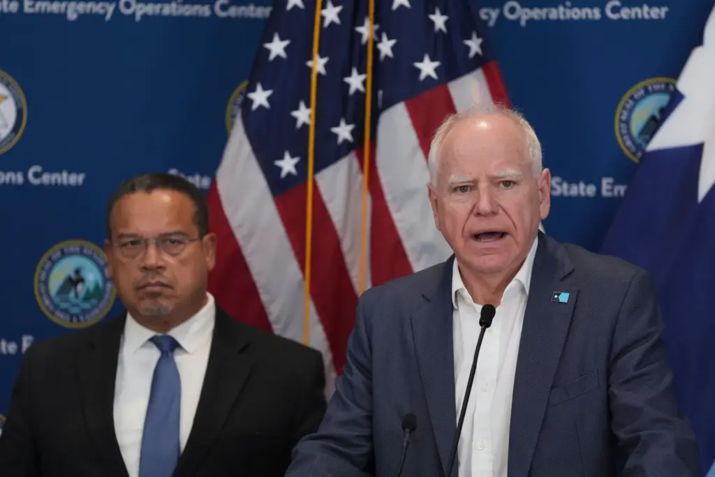CORRECTS PRETTY TO PRETTI – Minnesota Gov. Tim Walz, right,...