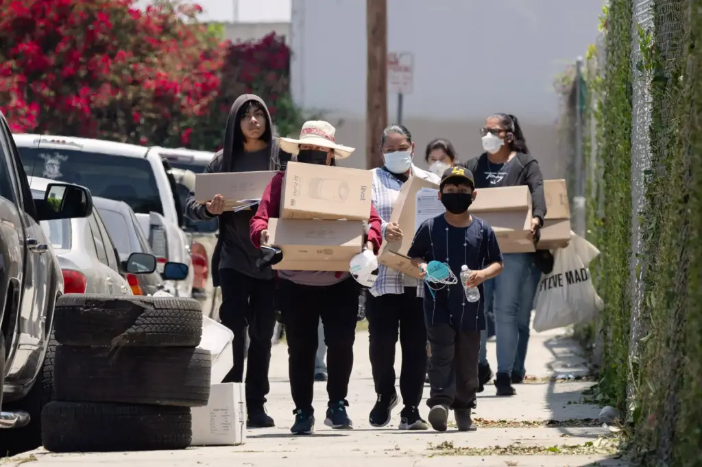 Residents affected by the Boyle Heights warehouse fire walk home...
