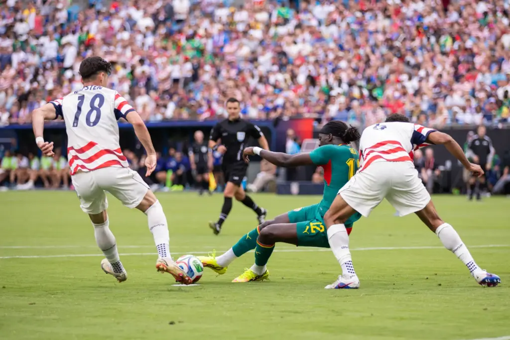 Senegal defender Cherif Ndiaye (12) loses his footing against United...