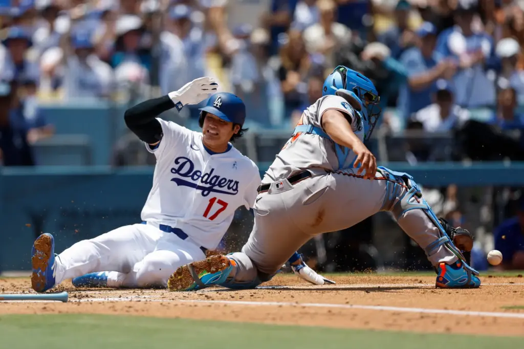 Dodgers designated hitter Shohei Ohtani (17) slides into home plate...