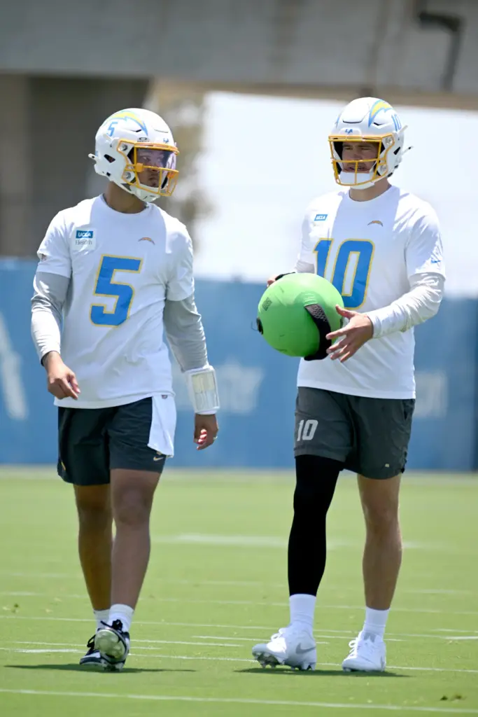 Chargers quarterbacks Justin Herbert (10) and Trey Lance (5) participate...