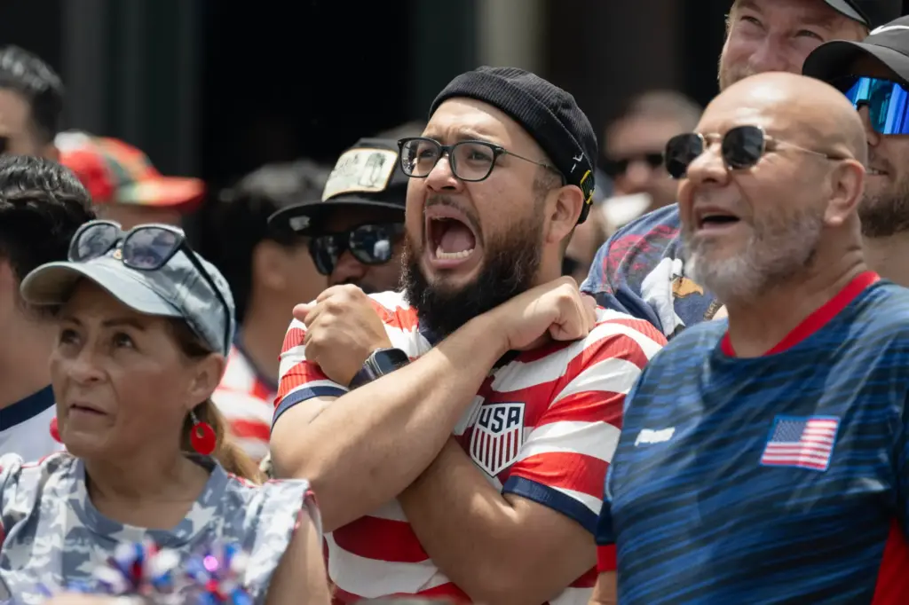 U.S.A. fans react to a serious foul resulting in a...
