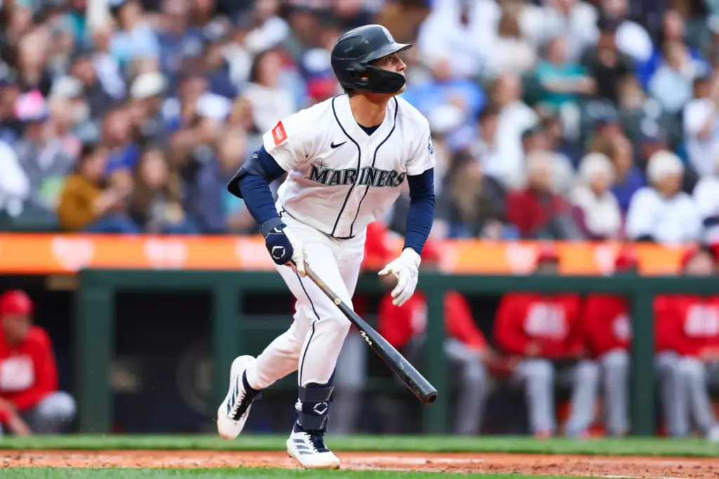 The Seattle Mariners’ Cole Young watches the flight of his...