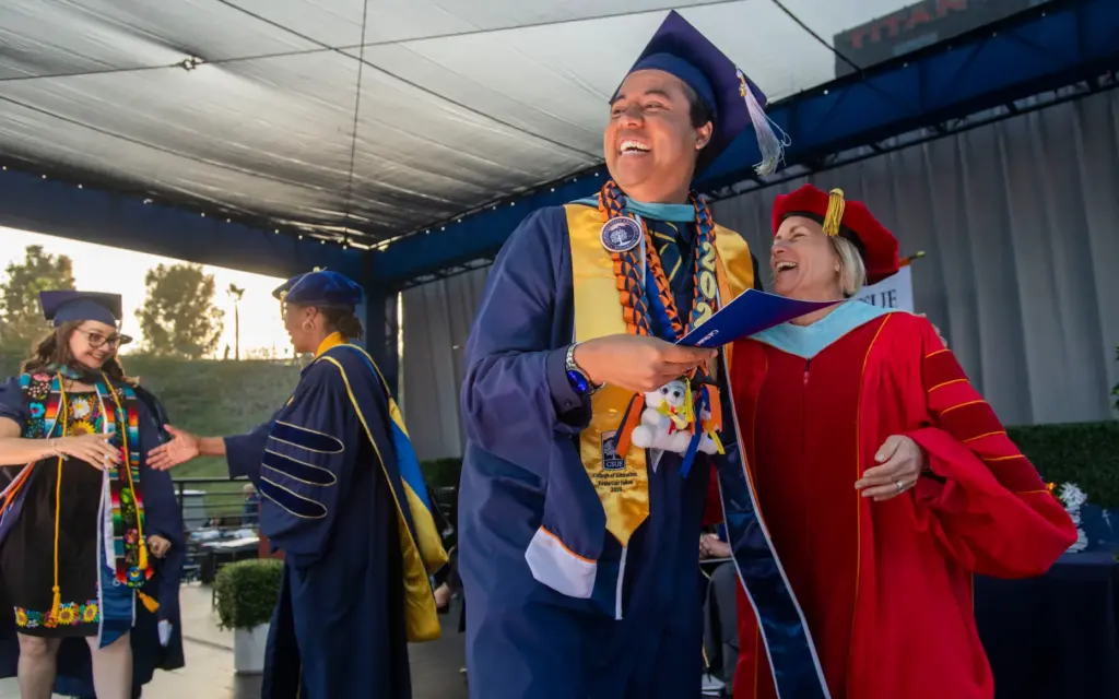 Kevin Greene is all smiles as he receives his diploma...